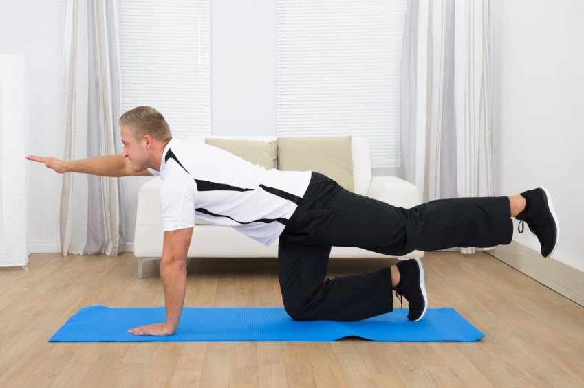 man performing bird-dog ab exercise