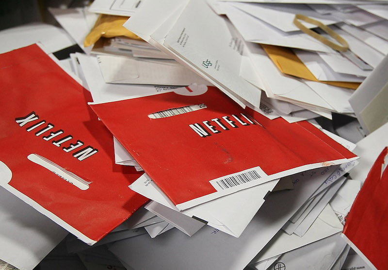 Netflix envelopes hold DVDs in a bin of mail