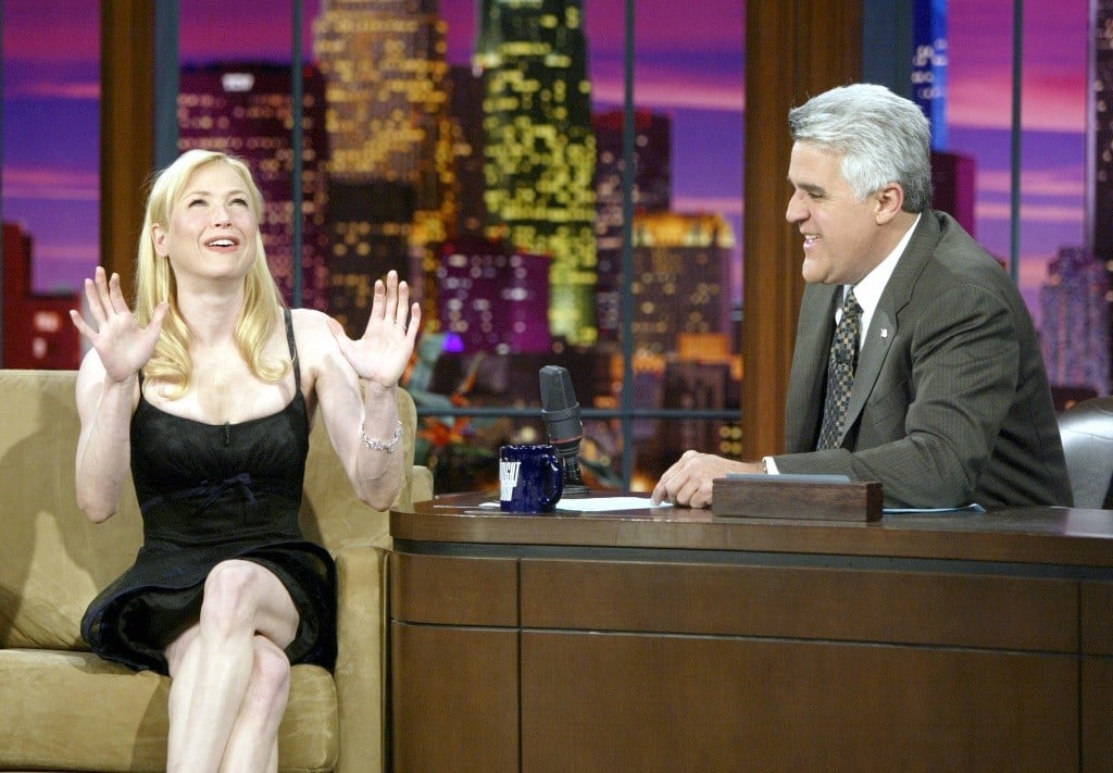Renee Zelwegger with his hands out, talking to a smiling Jay Leno on TV