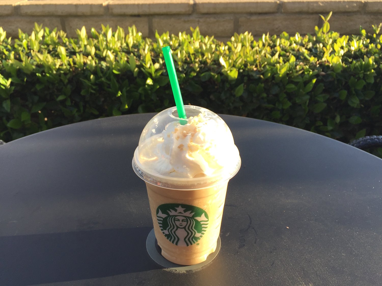 Starbucks Caramelized Honey Frappuccino on patio table