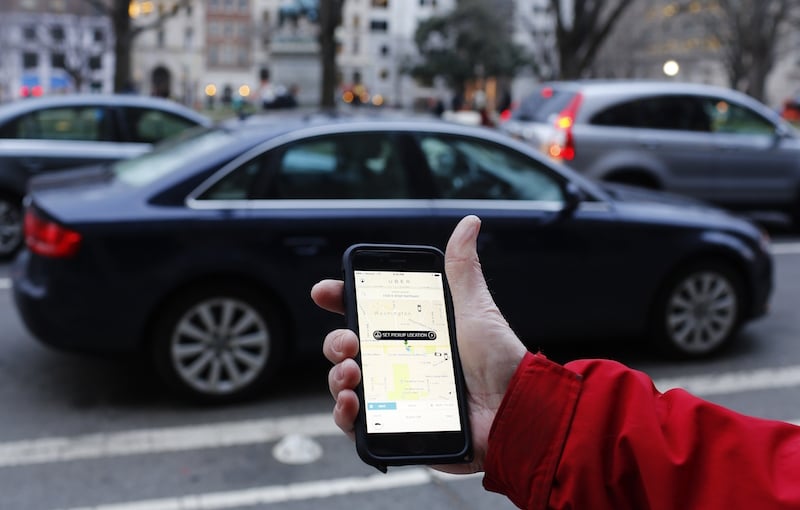 An UBER application is shown as cars drive by in Washington, DC on March 25, 2015. Uber said it was ramping up safety in response to rape allegations against a driver in India and growing concerns about background checks for operators of the popular ride-sharing service. In other cities where Uber operates, critics had complained that a lack of licensing and background checks of drivers could imperil those who use the service. AFP PHOTO/ ANDREW CABALLERO-REYNOLDS (Photo credit should read Andrew Caballero-Reynolds/AFP/Getty Images) The Uber app shown as cars drive by