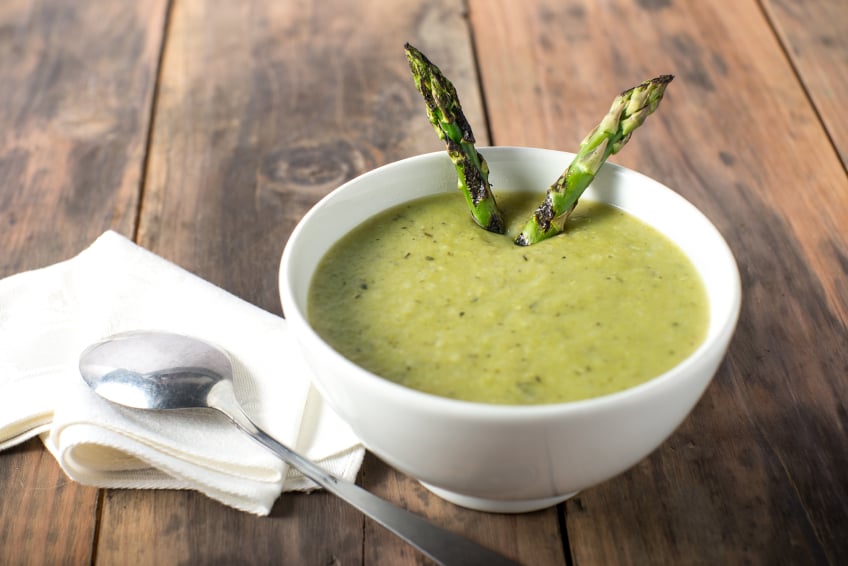 asparagus soup in a white bowl