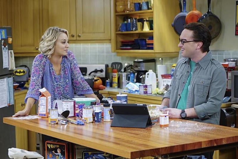 Leonard and Penny stand at a kitchen island in The Big Bang Theory