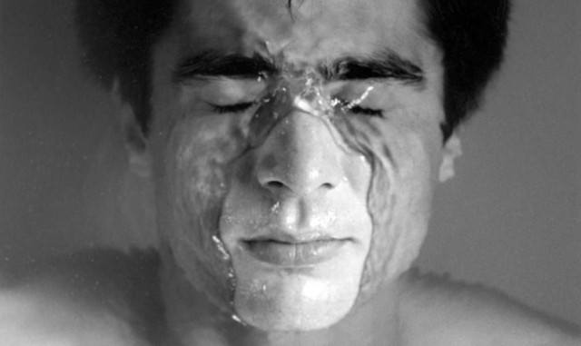 One of Robert Mapplethorpe's photographs, featuring a young man submerging himself in water.