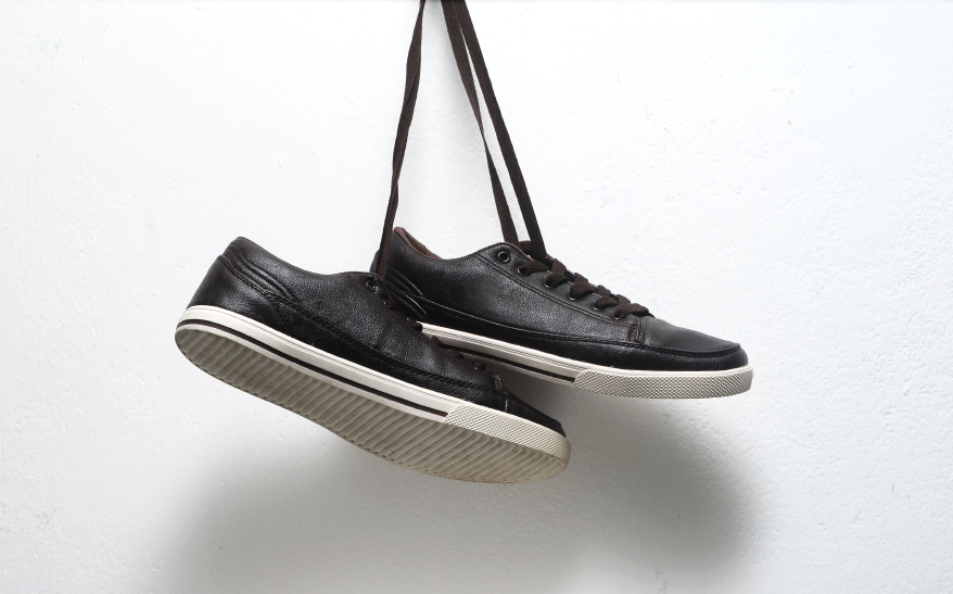 two black shoes hanging from laces