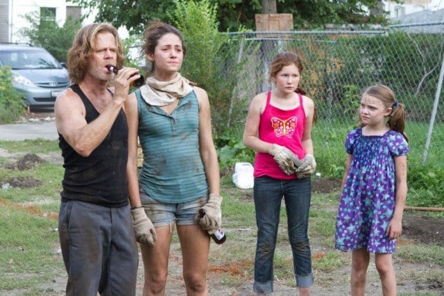The Gallagher family stand outside, looking a bit worse for wear, in a scene from 'Shameless'