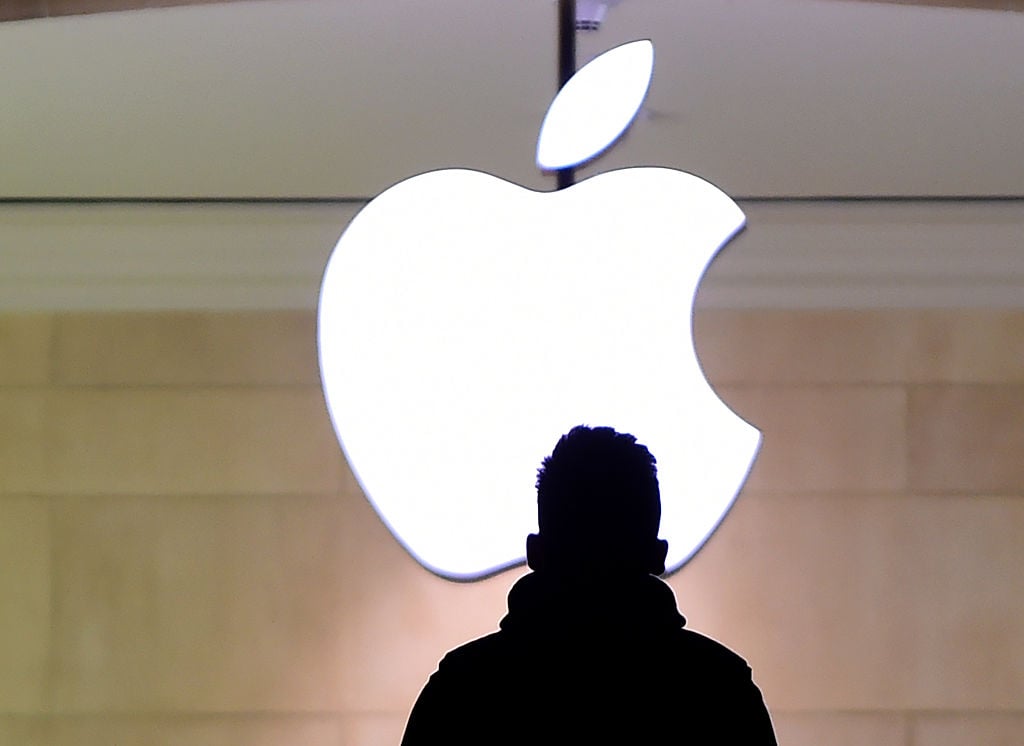 Man standing in front of Apple logo