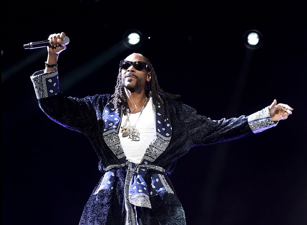 Snoop Dogg is on stage in a robe.