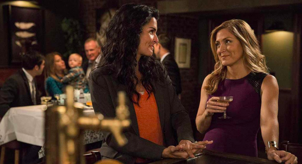 Angie Harmon and Sasha Alexander chat at a restaurant in a scene from Rizzoli and Isles