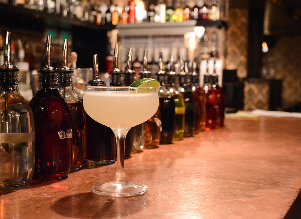 Daiquiri garnished with lime sitting on a bar