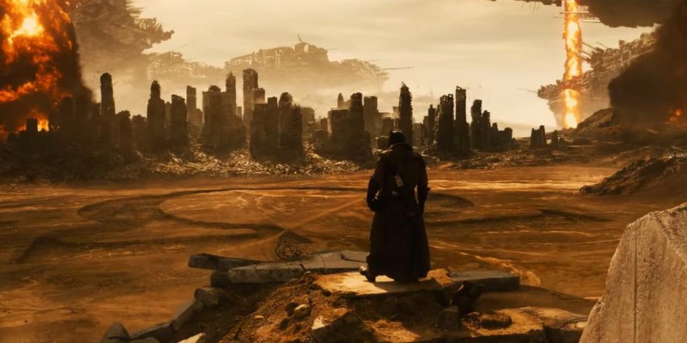 Batman looks over a destroyed hist in Batman v Superman
