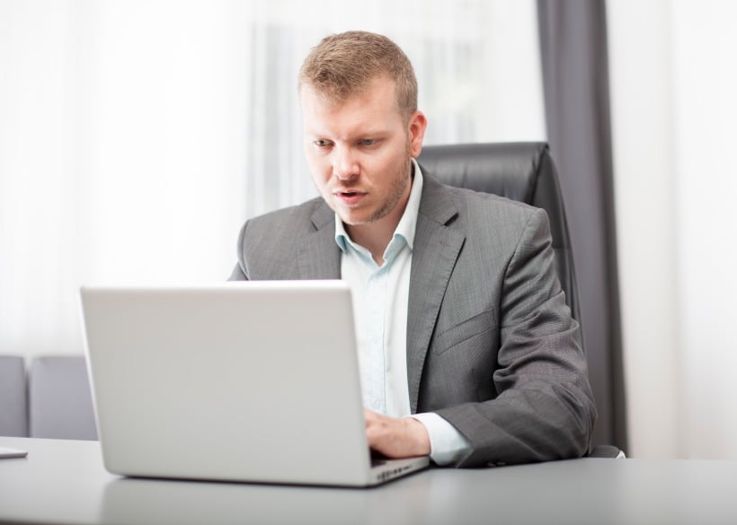 Businessman looking at his laptop