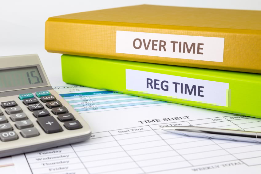 Overtime and Regular time registers with calculator on a table