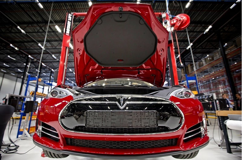 open hood of red European-spec Tesla Model S