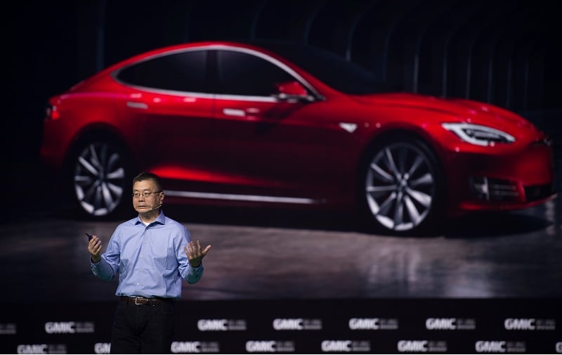 Robin Ren Global VP and Head of APAC Tesla Motors makes a speech during the Global Mobile Internet Conference (GMIC) at the National Convention Centre in Beijing on April 28, 2016. GMIC is hosting mobile executives, entrepreneurs, developers, and investors from around the world.
