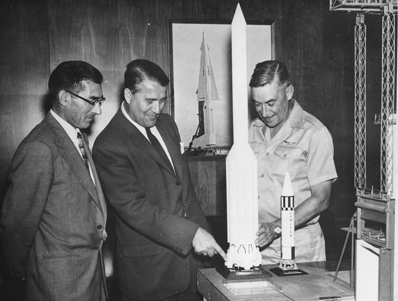 Aerospace Engineer Wernher Von Braun (centre) explaining his model of the Saturn Rocket