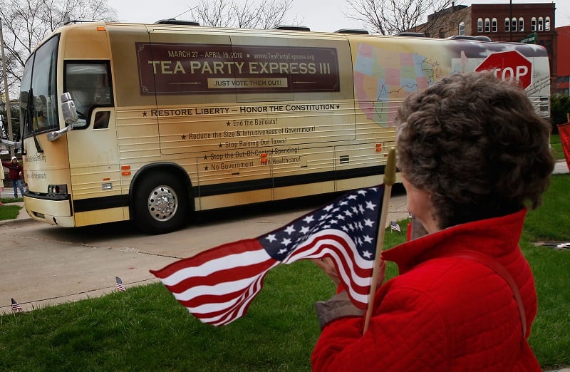 A Tea Party supporter watches as buses from the Tea Party Express national tour arrive in Rockford