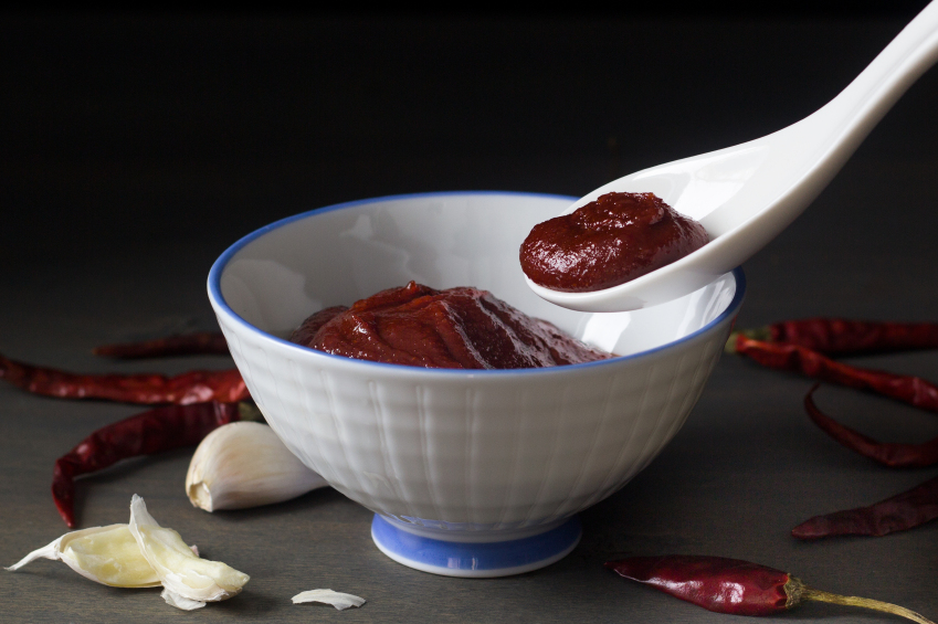 Gochujang in white bowl with red chillies