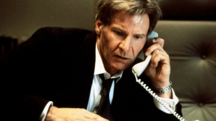 Harrison Ford wears a suit and talks on the phone as President Jim Marshall in Air Force One Harrison Ford wears a suit and talks on the phone as President Jim Marshall in Air Force One