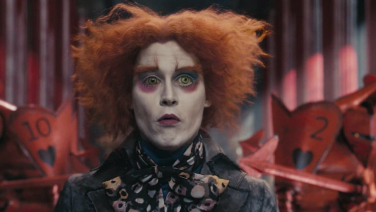Johnny Depp wears face paint and dons red hair in 'Alice in Wonderland' seen staring straight ahead.