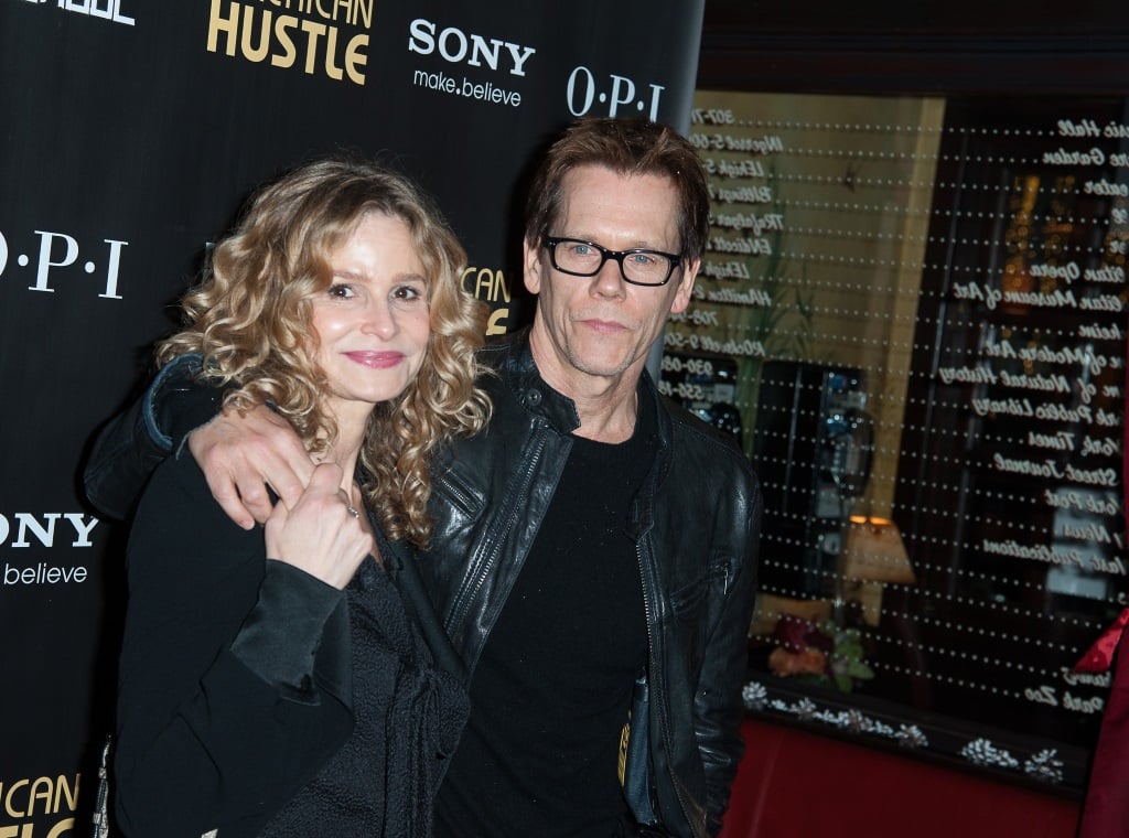 Kevin Bacon has his arm around Kyra Sedgwick on the red carpet.