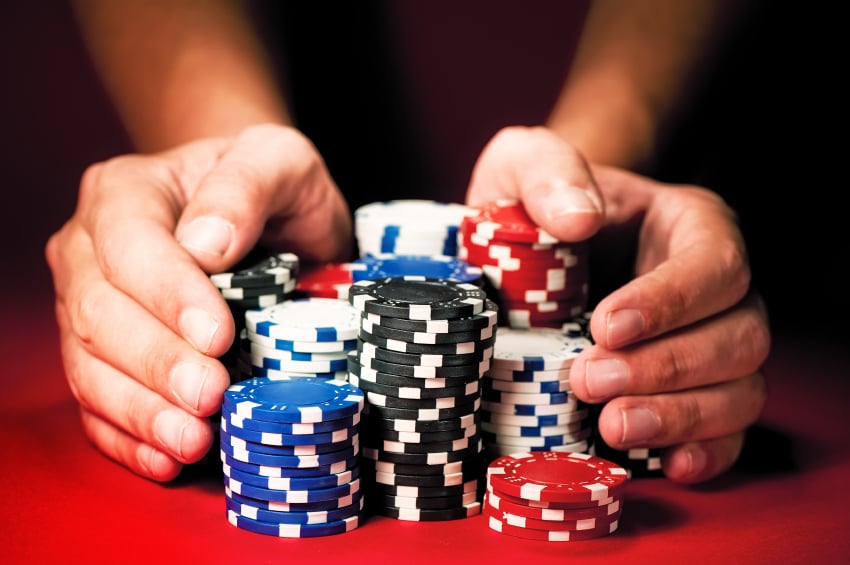 hands holding casino chips