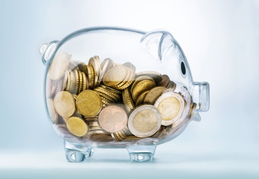 piggy bank a glass see through piggy bank full of coins