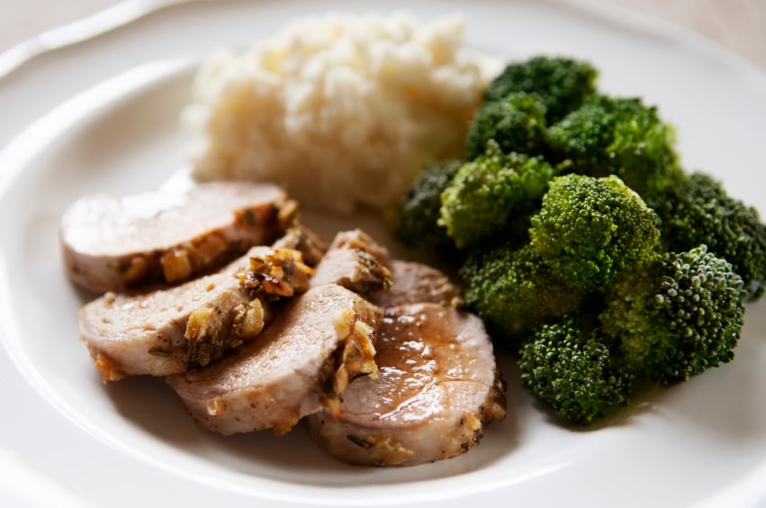 Sliced, crusted pork tenderloin with broccoli and gains