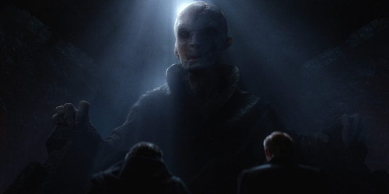Supreme Leader Snoke, half-lit, sits in a large chair, looking down at the camera Supreme Leader Snoke, half-lit, sits in a large chair, looking down at the camera