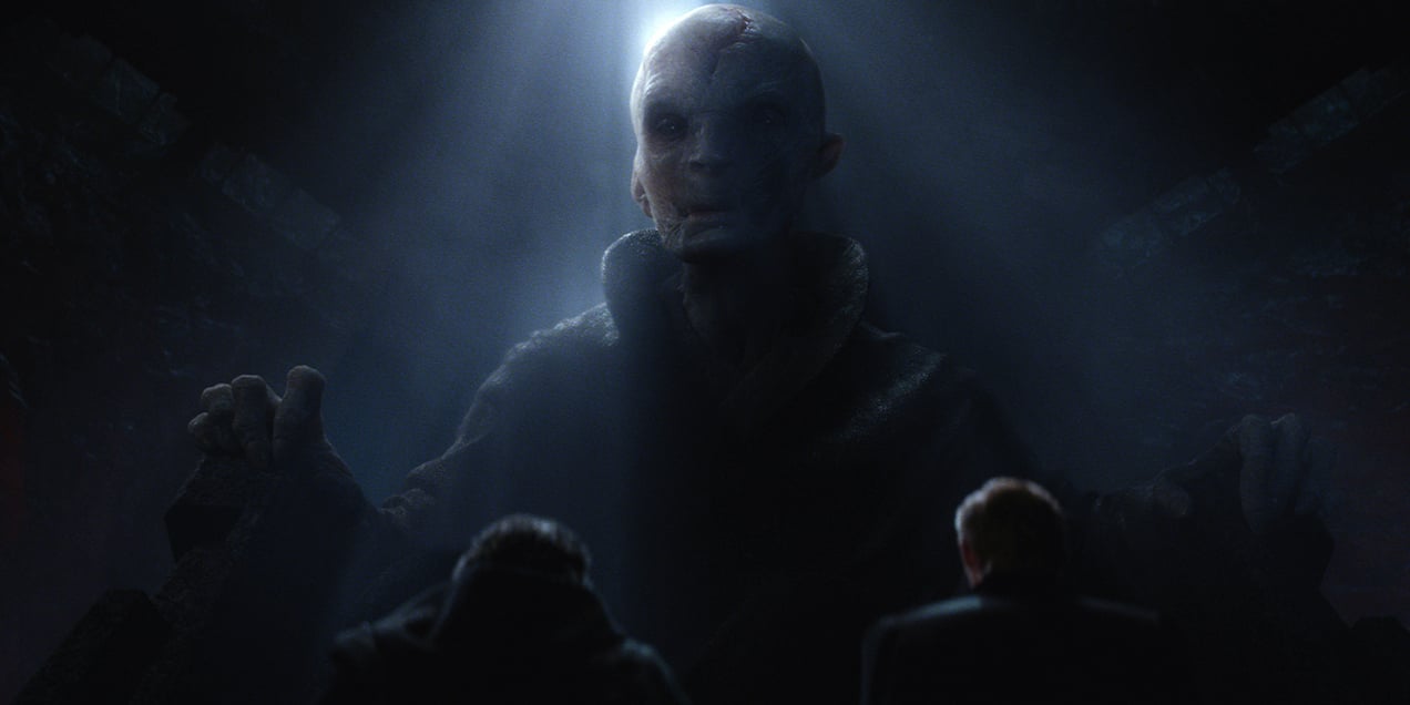 Supreme Leader Snoke, half-lit, sits in a large chair, looking down at the camera Supreme Leader Snoke, half-lit, sits in a large chair, looking down at the camera