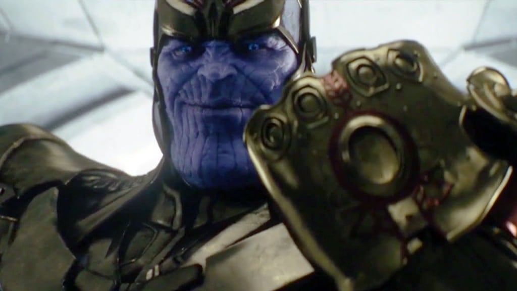 Thanos holding up his gloved hand and smiling