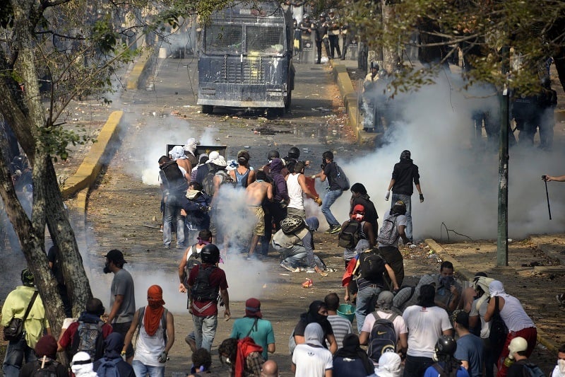 Venezuelan students clash with riot police during a protest against the government