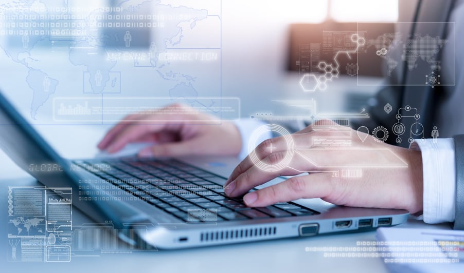 man typing on laptop