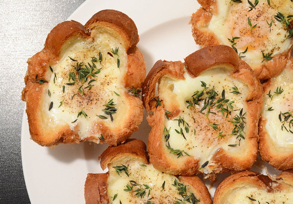 overhead shot of a plate filled with croque madame egg cups