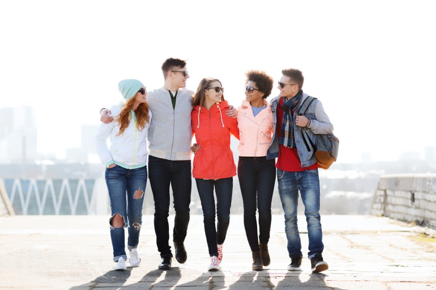 group of young friends walking together on a sunny day