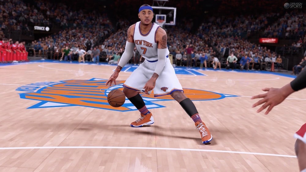 A basketball player dribbles up to the basket in NBA 2K16