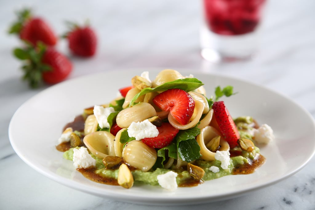 strawberry and orechiette pasta salad on a white plate