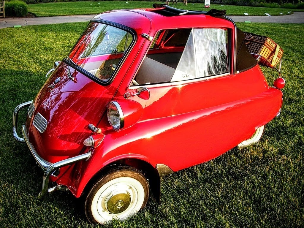 Red BMW Isetta parked on grass