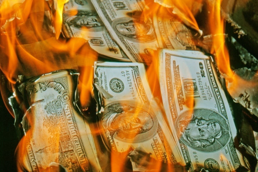Dollar bills burning in fire