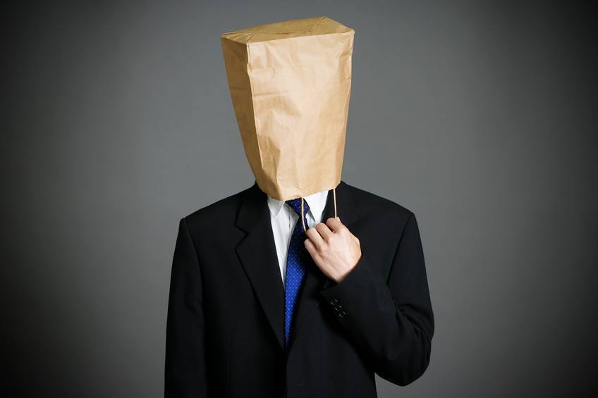 Businessman wearing paper bag on face