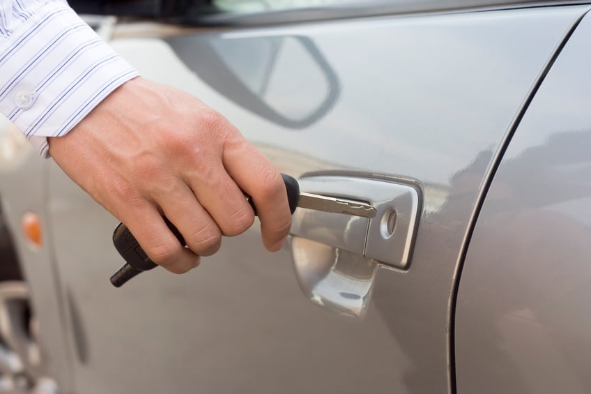 man inserting car key into lock hole, car product testing