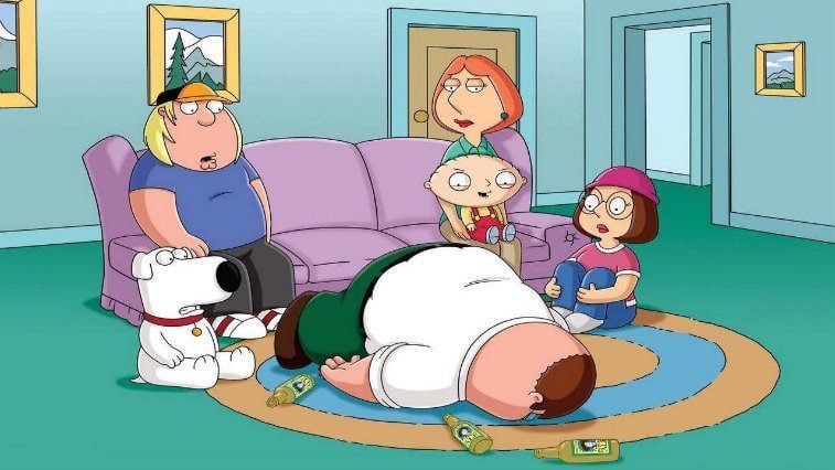 The Griffins in their living room crowded around Peter who is lying face-down on the floor The Griffins in their living room crowded around Peter who is lying face-down on the floor