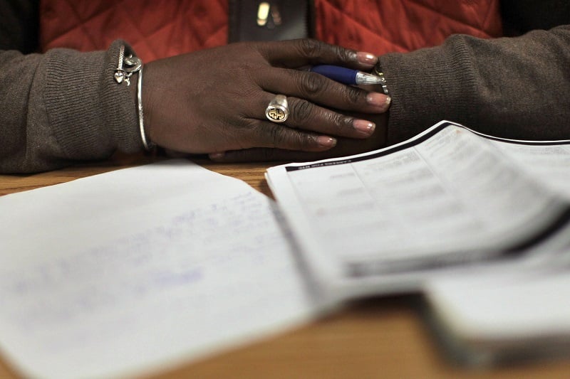 A woman writes a cover letter at a career training center