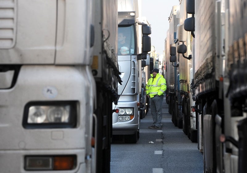 A truck driver waiting in line