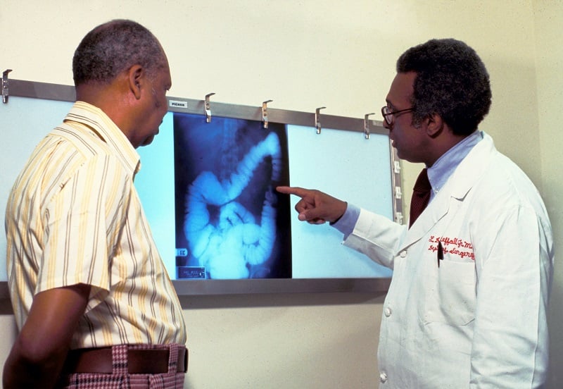 A doctor and patient looking at cancer images