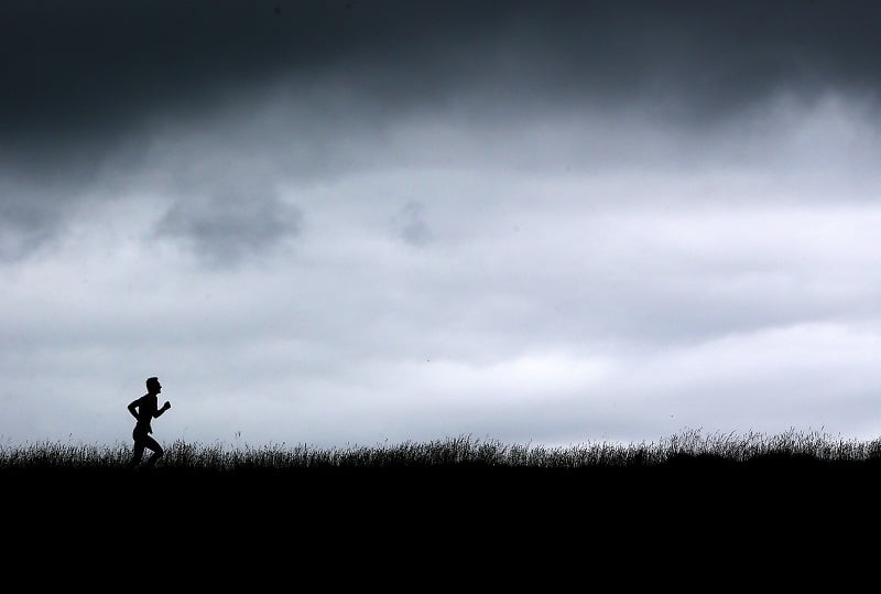 A man running through the English countryside