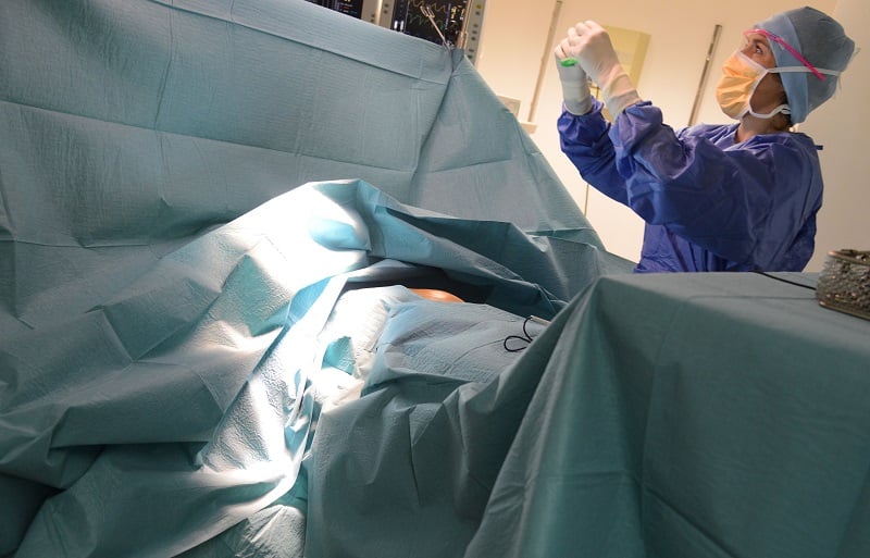 Doctors perform surgery on a cancer patient