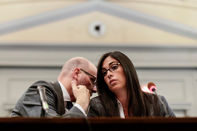A woman listens to her attorney during a hearing | Kena Betancur/Getty Images
