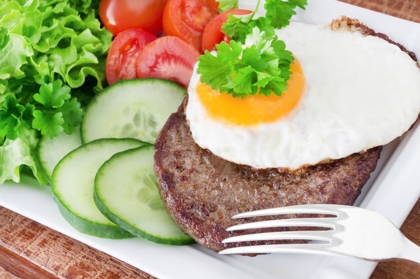 Hamburger with fired egg and salad