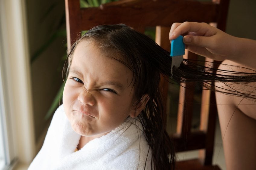 girl getting lice treatment